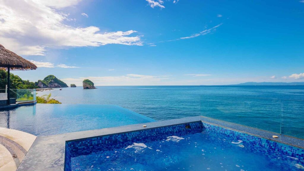 The Panoramic view of Puerto Vallarta coastline from a luxury villa infinity pool