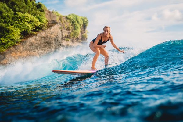 A woman riding a wave in Cabo del Sol