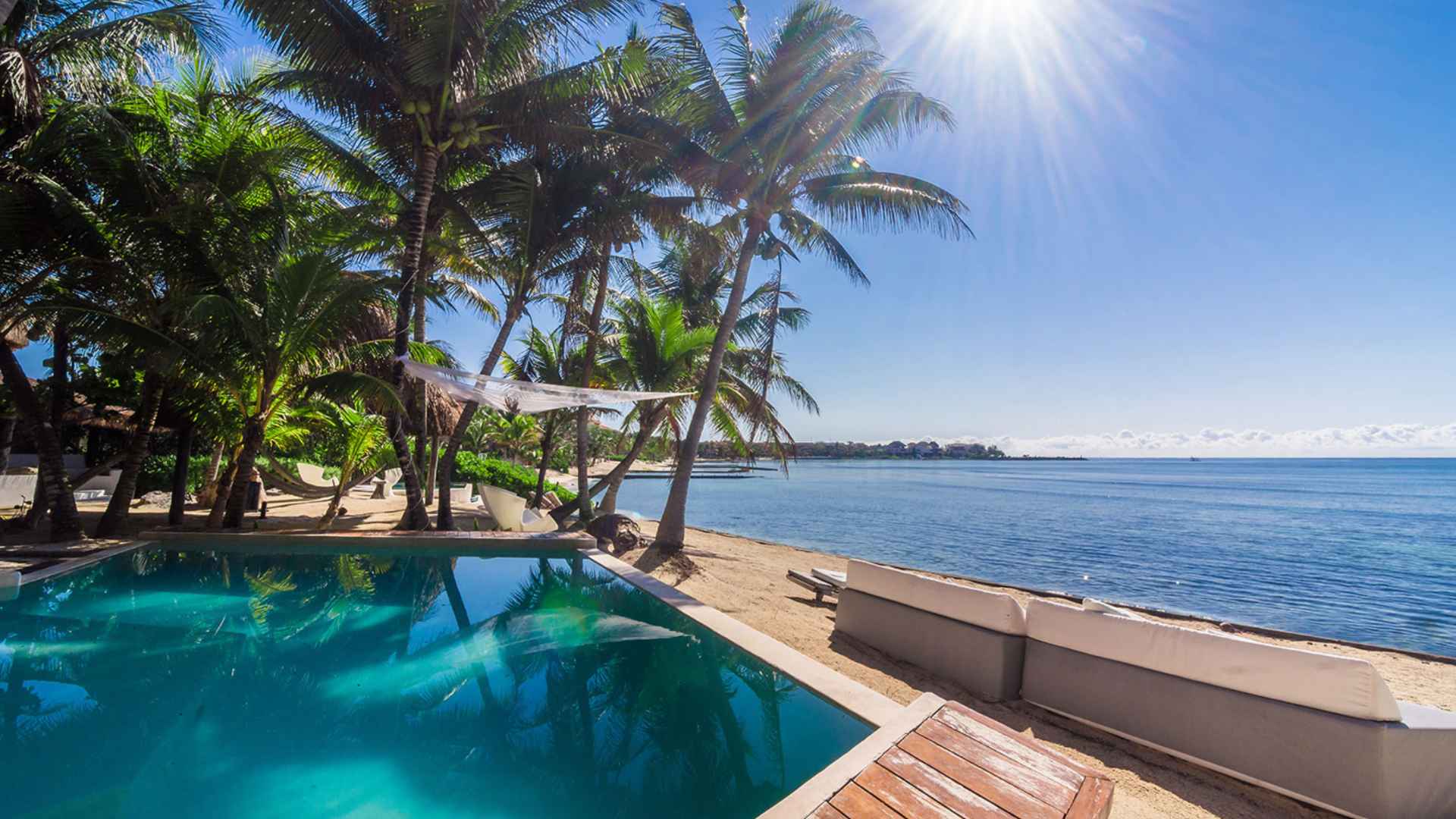 Puerto Estate, a Riviera Maya luxury villa with heated infinity pool, Caribbean ocean views, and beachfront outdoor living area